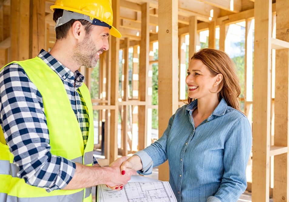 Engineer or architect on construction site of new house reach agreement with investor and home owner giving handshake